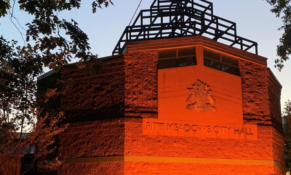 Pitt Meadows City Hall lit up in orange lights
