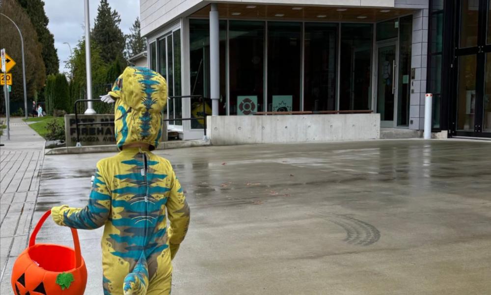 child in Halloween costume walking to Pitt Meadows Fire Hall