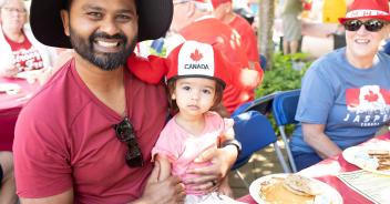 photo of parent and child in red white clothing at breakfast