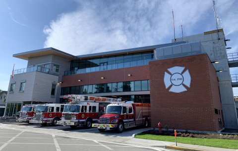 Front of new fire hall with 3 firetrucks out front
