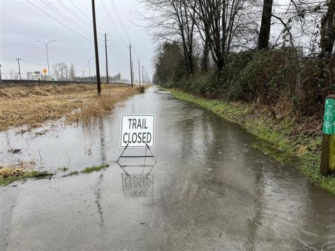Image of CP Trail with localized flooding and a trail closed sign