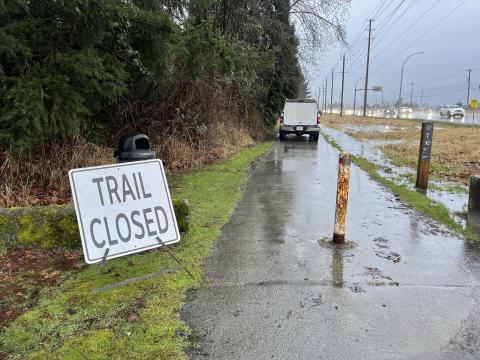 Image of CP Trail with localized flooding and a trail closed sign