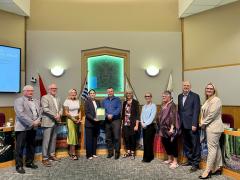 City councillors, finance department staff and communications staff holding an award